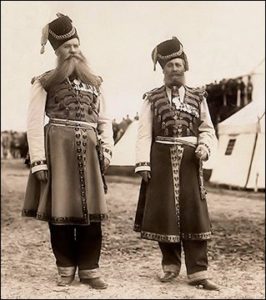 Center: Archival photograph of Kudinov and Pustynnikov in their ceremonial dress at annual military maneuvers presided over by Nicholas II in 1913. (Photographs Courtesy of Sammler.ru)